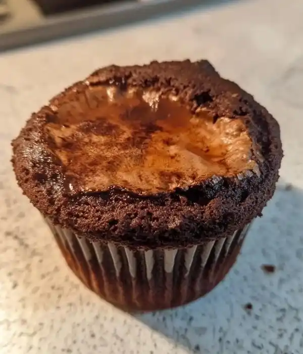 Early baking fail: a sunken homemade chocolate cupcake from one of my first recipe tests